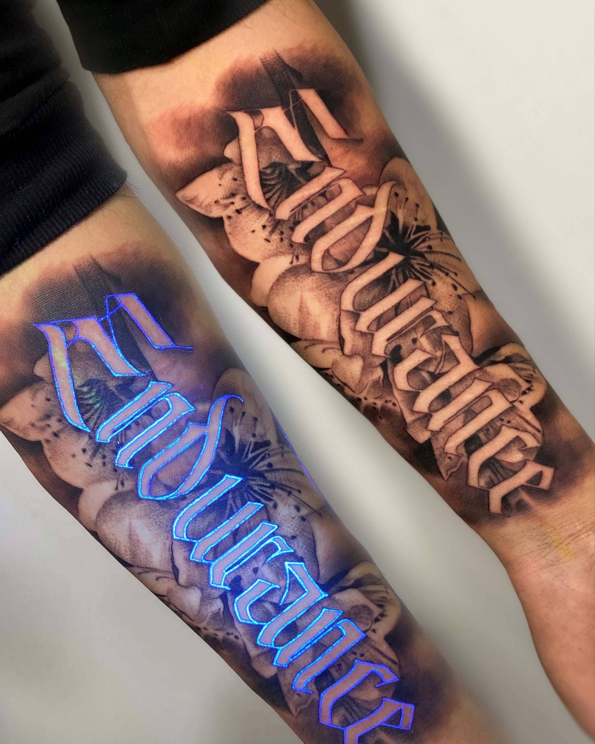 UV-reactive lettering tattoo with black and grey background