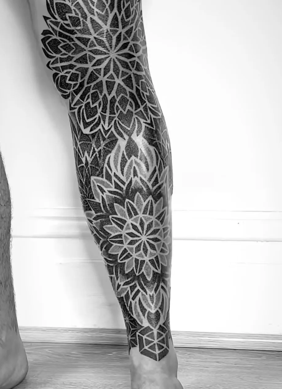 Lower leg geometric sleeve with intricate dotwork patterns by Alex Berin