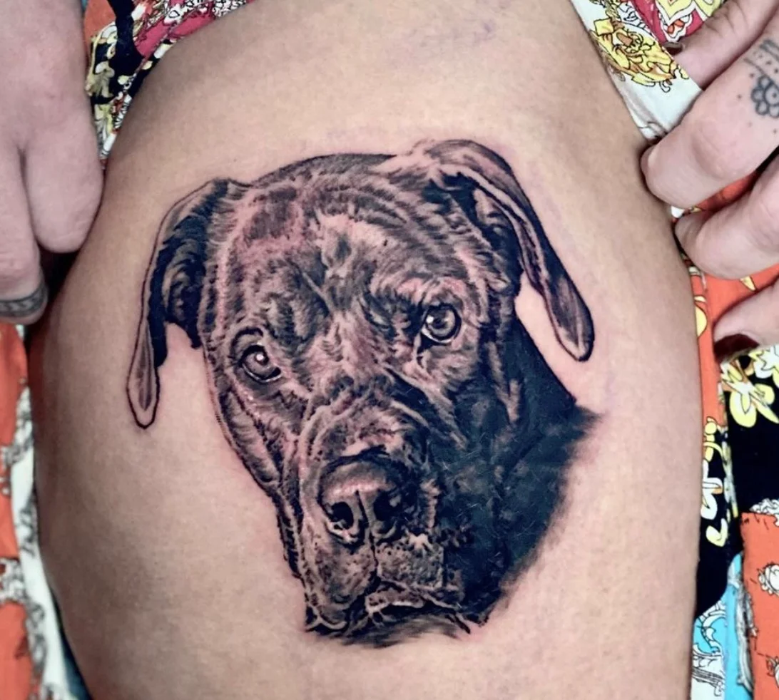 Photorealistic puppy portrait tattoo with lifelike detail and expression by Karlo at Omnia Tattoo Melbourne