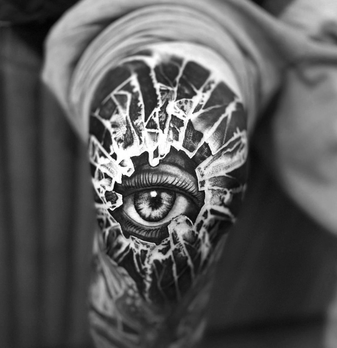 Eye with broken glass surrealist tattoo by Dylan James with fine detail