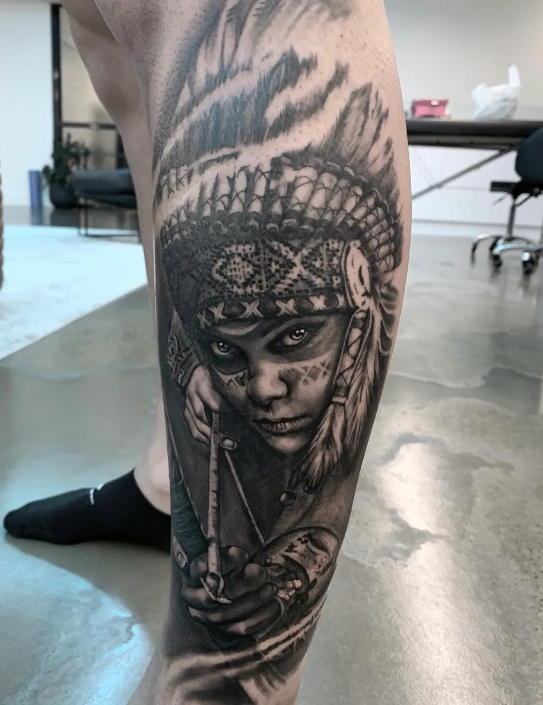 Native American bow hunting detailed leg sleeve tattoo by Dylan James