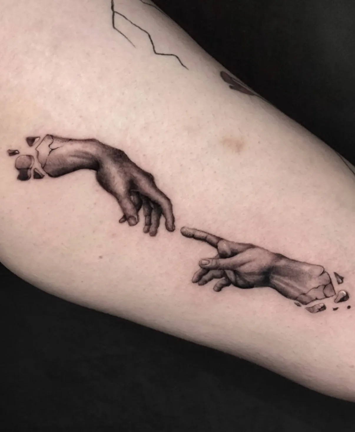 Michelangelo's Creation of Adam hands tattoo recreation with fine detail